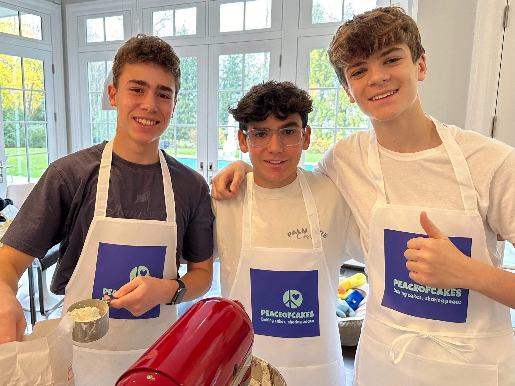 Three young PeaceofCakes bakers working together