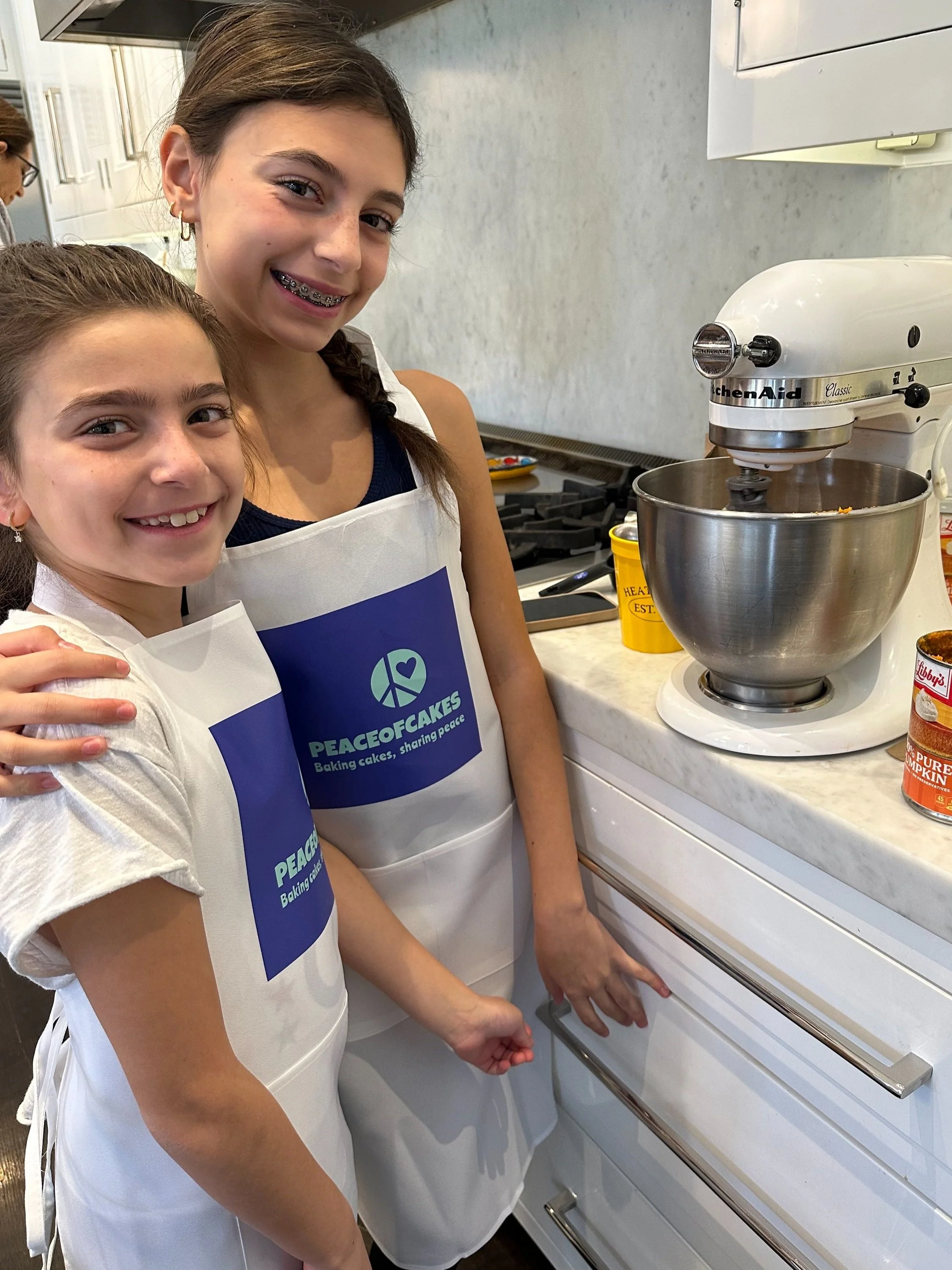 Young baker presenting a PeaceofCakes donation