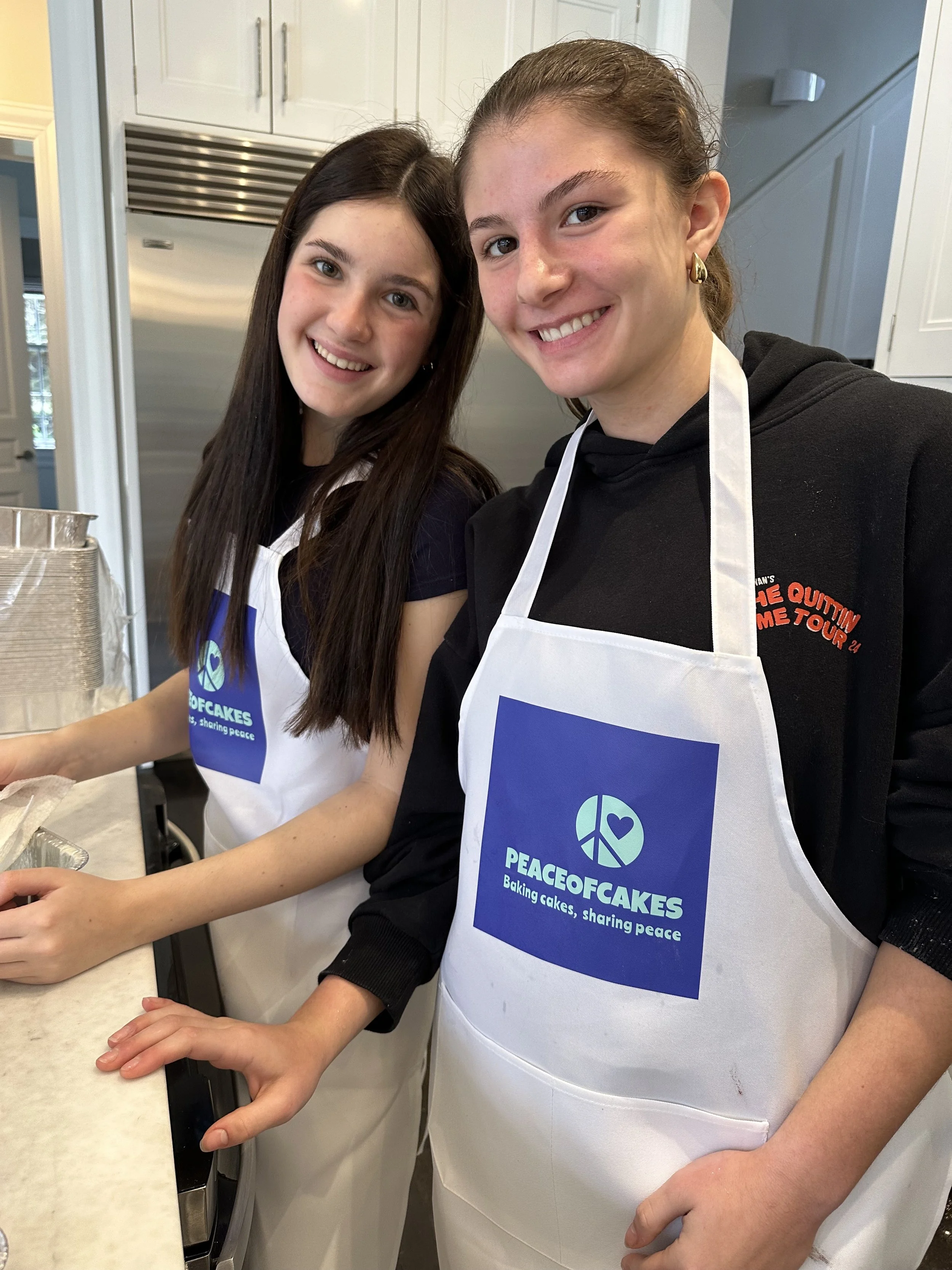Young baker standing behind packaged cakes