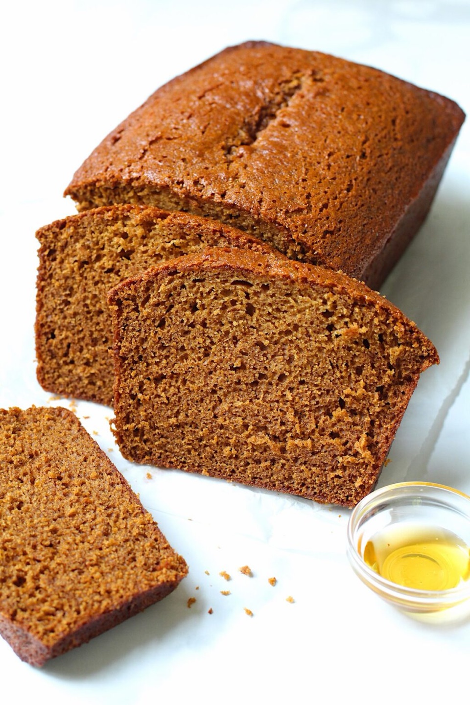 Honey loaf cake, sliced, with a small dish of honey